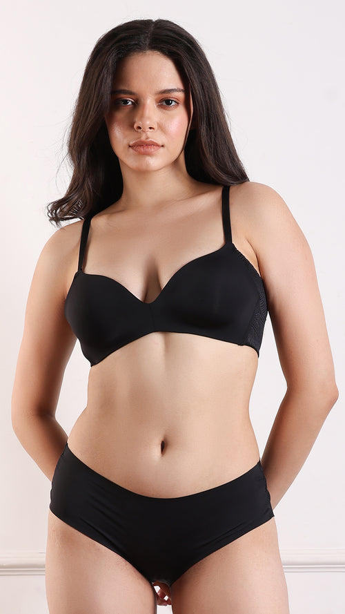 Woman wearing black seamless plunge bra and briefs, front view