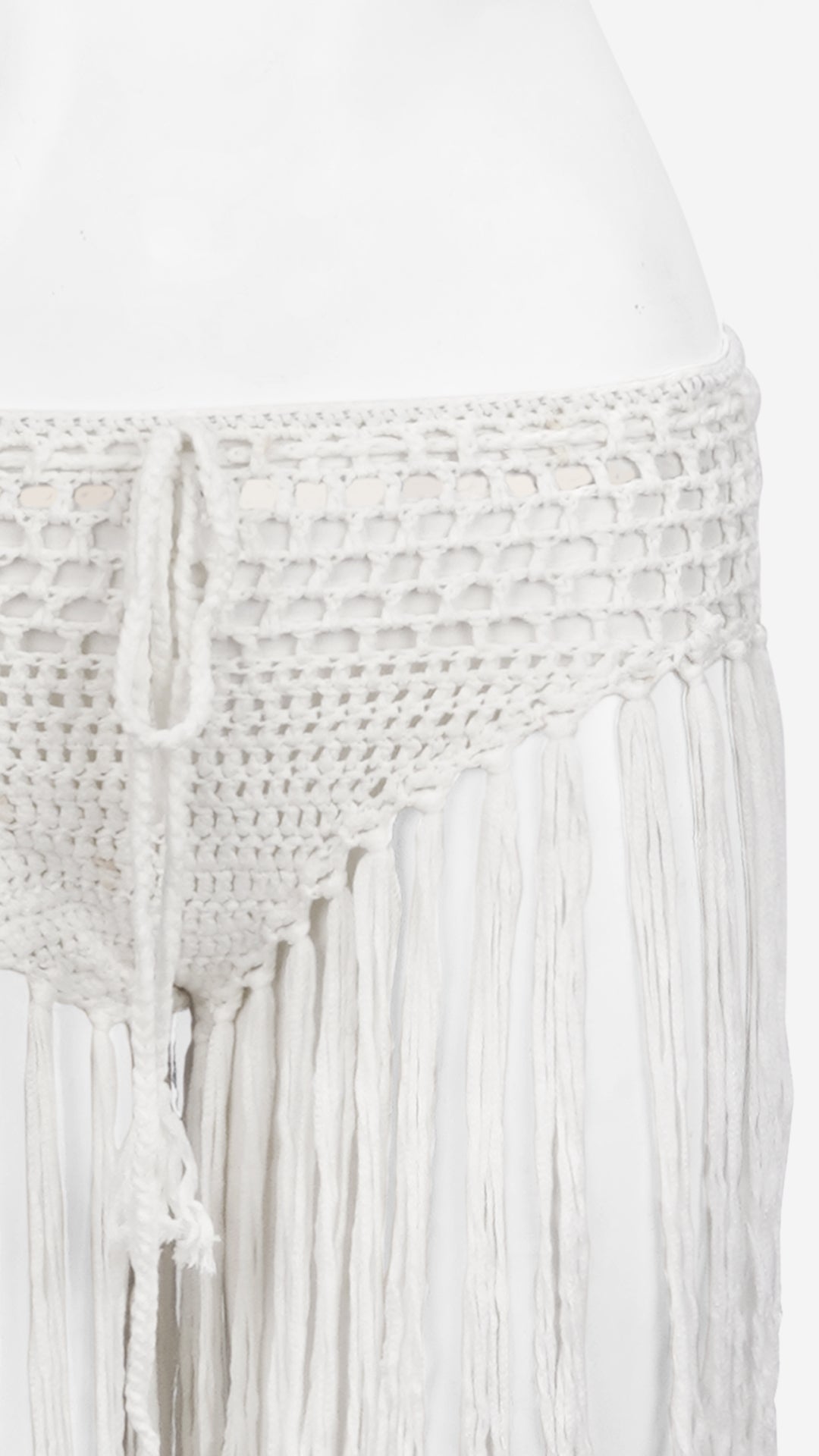 Close-up of white crochet fringe bottom waistband and tie detail