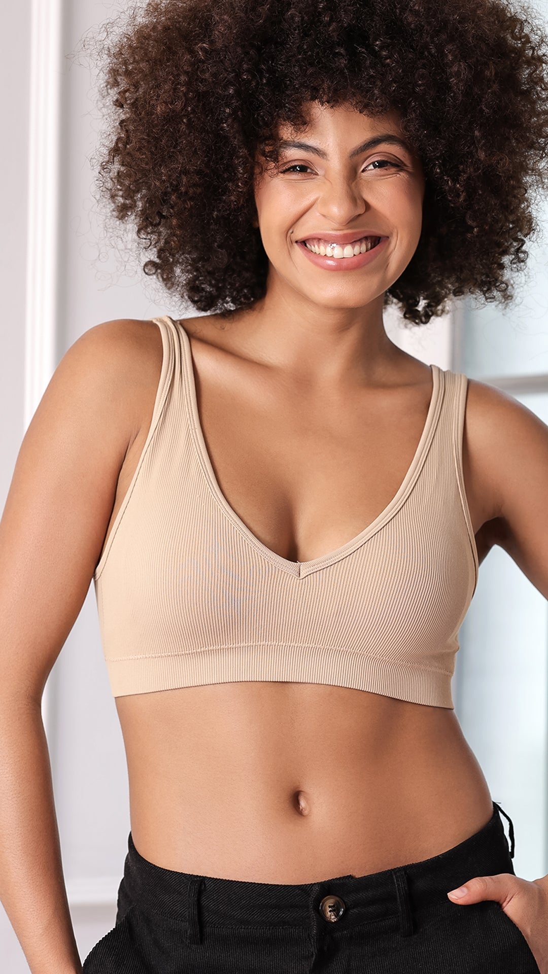 Model wearing beige ribbed V-neck wireless bra, front view