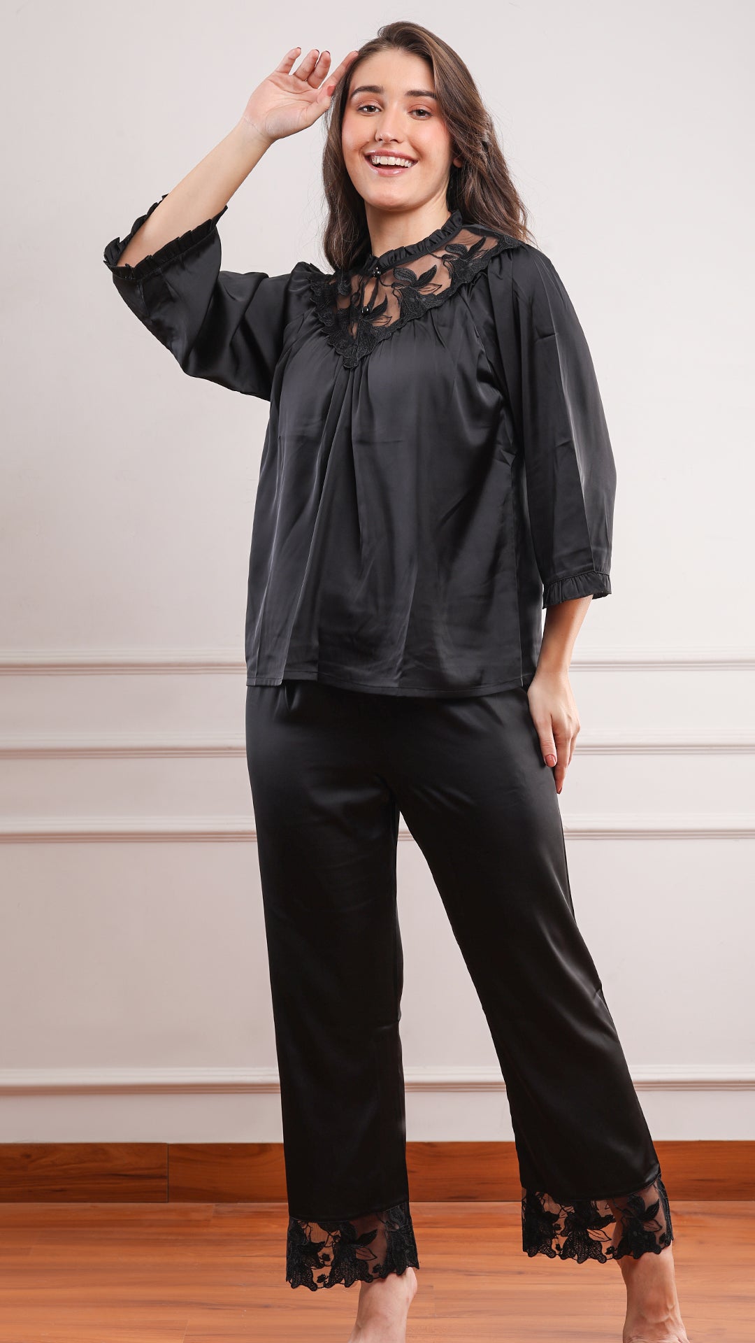 Relaxed black satin pajama set with lace neckline and straight-leg pants