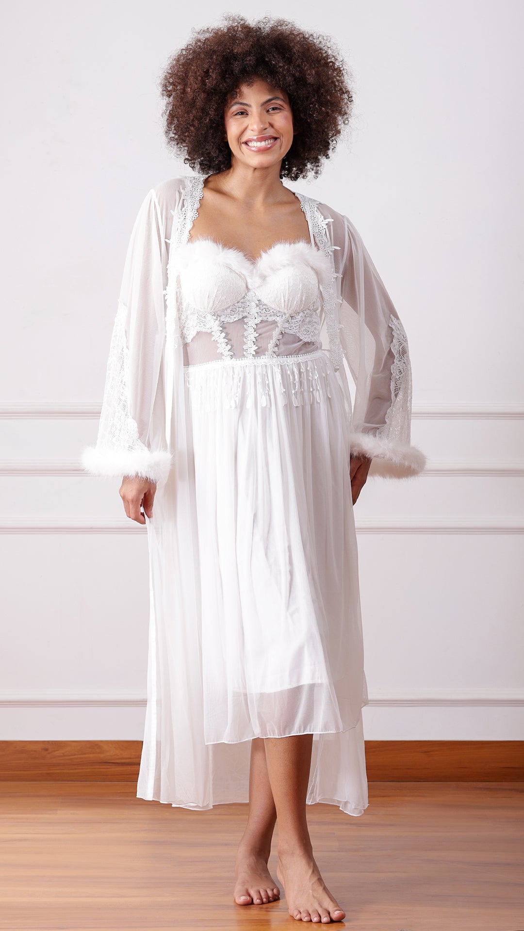 Woman wearing white feather-trim lace nightgown with matching robe