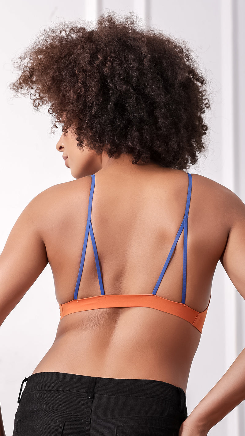 Back view of orange bralette showing crisscross blue strap design