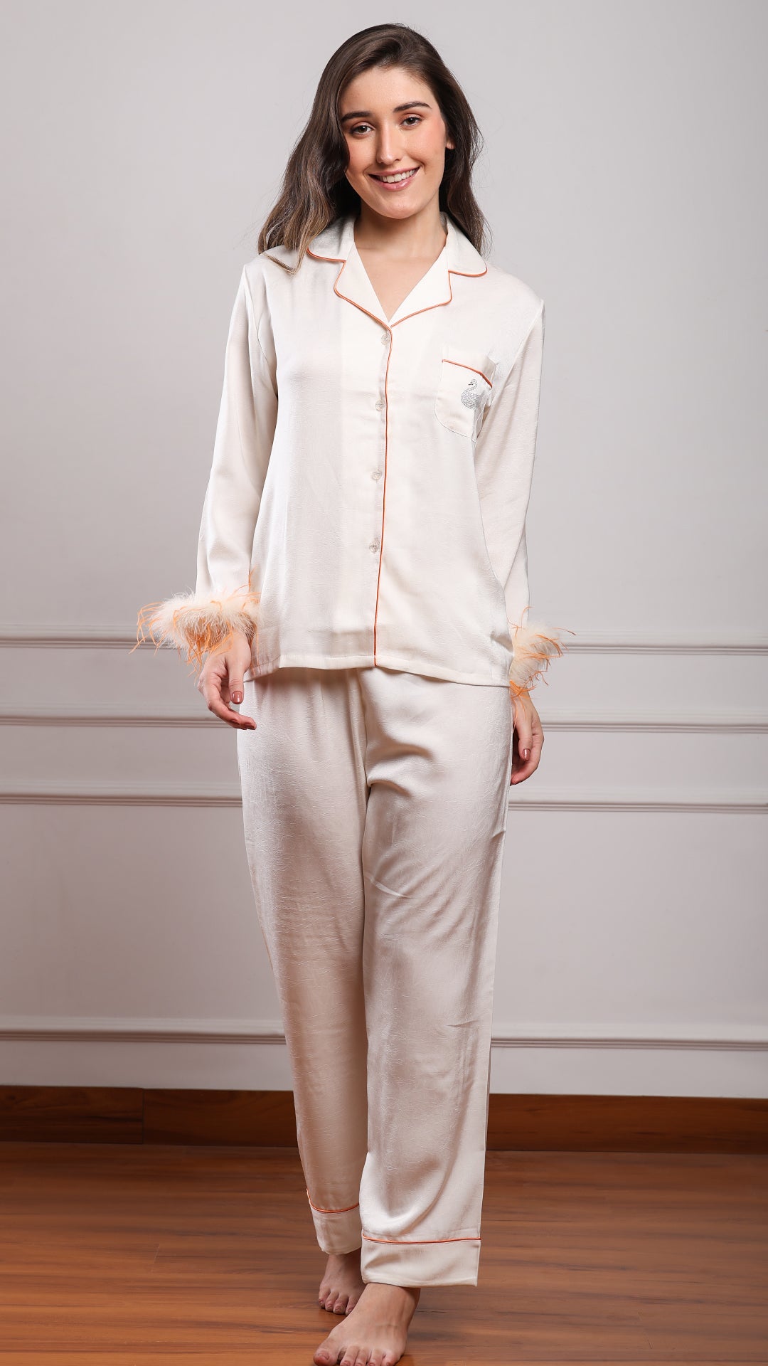 Women's ivory satin pajama set with feather cuffs, long sleeve shirt and straight leg pants for bridal loungewear