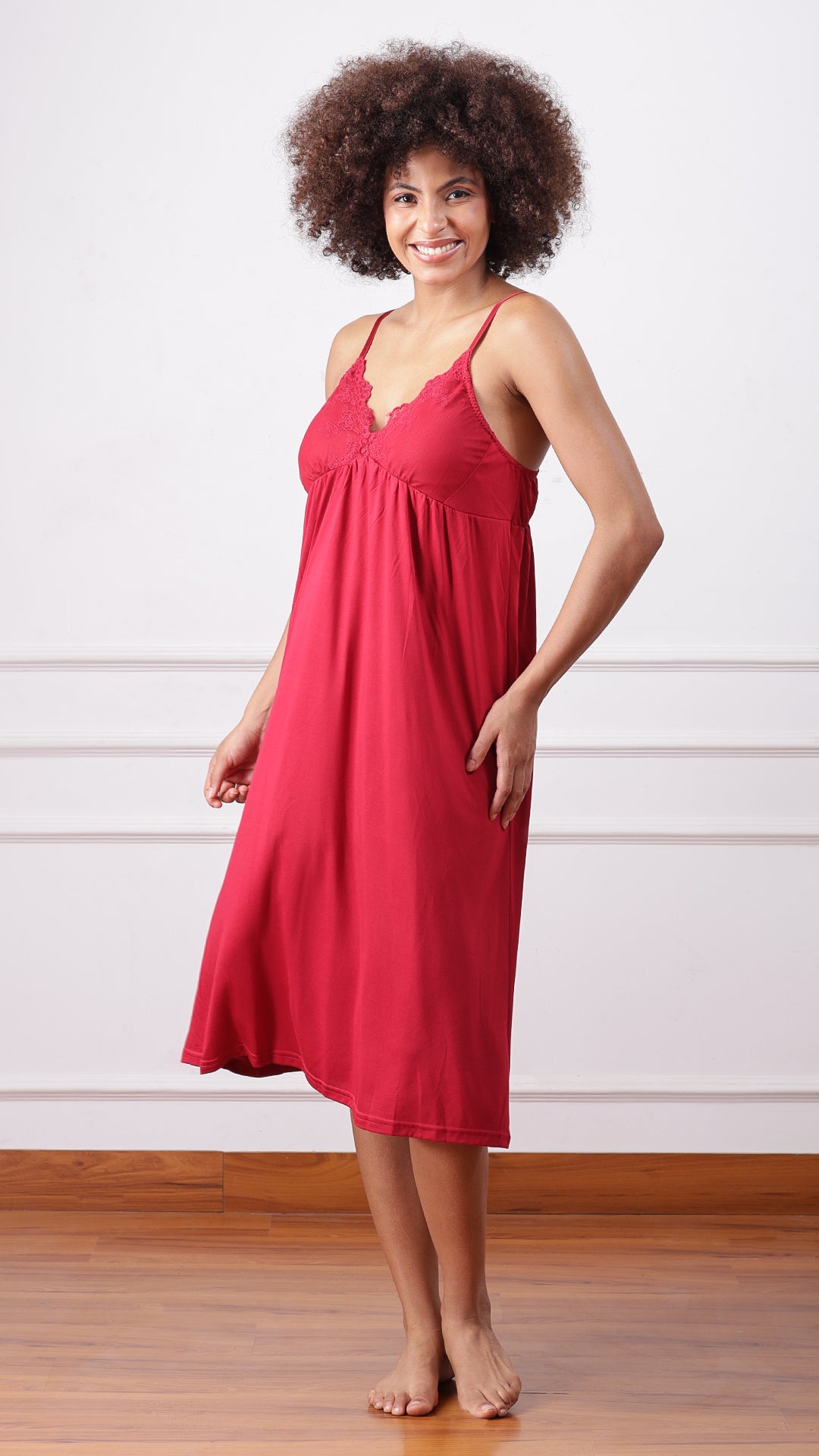 Woman wearing red jersey nightdress with lace trim, front view