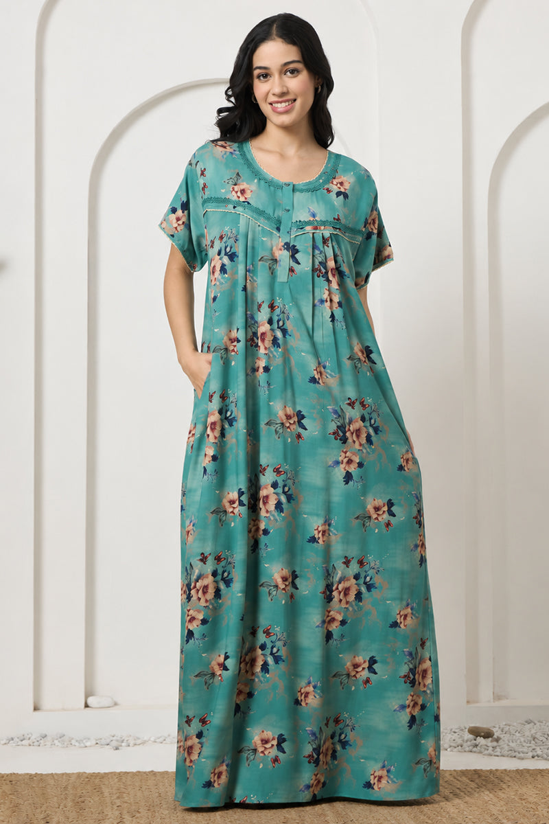 Woman smiling in a teal floral print nightgown