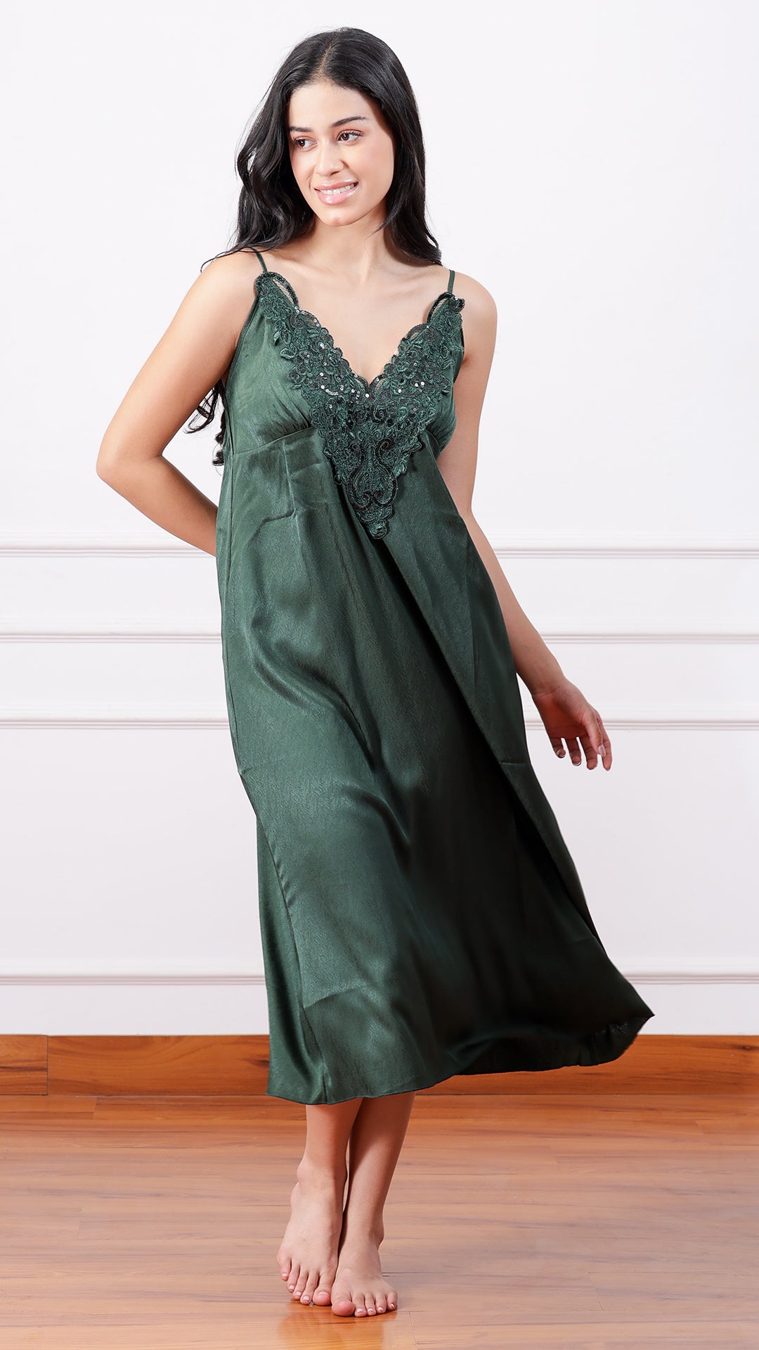 Woman posing in dark green satin nightdress, front view