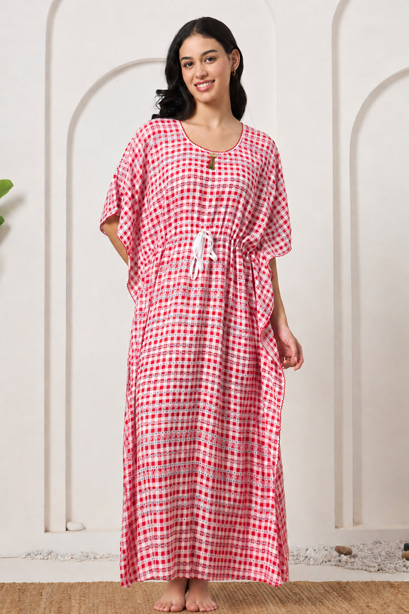 Woman smiling in a red gingham check kaftan