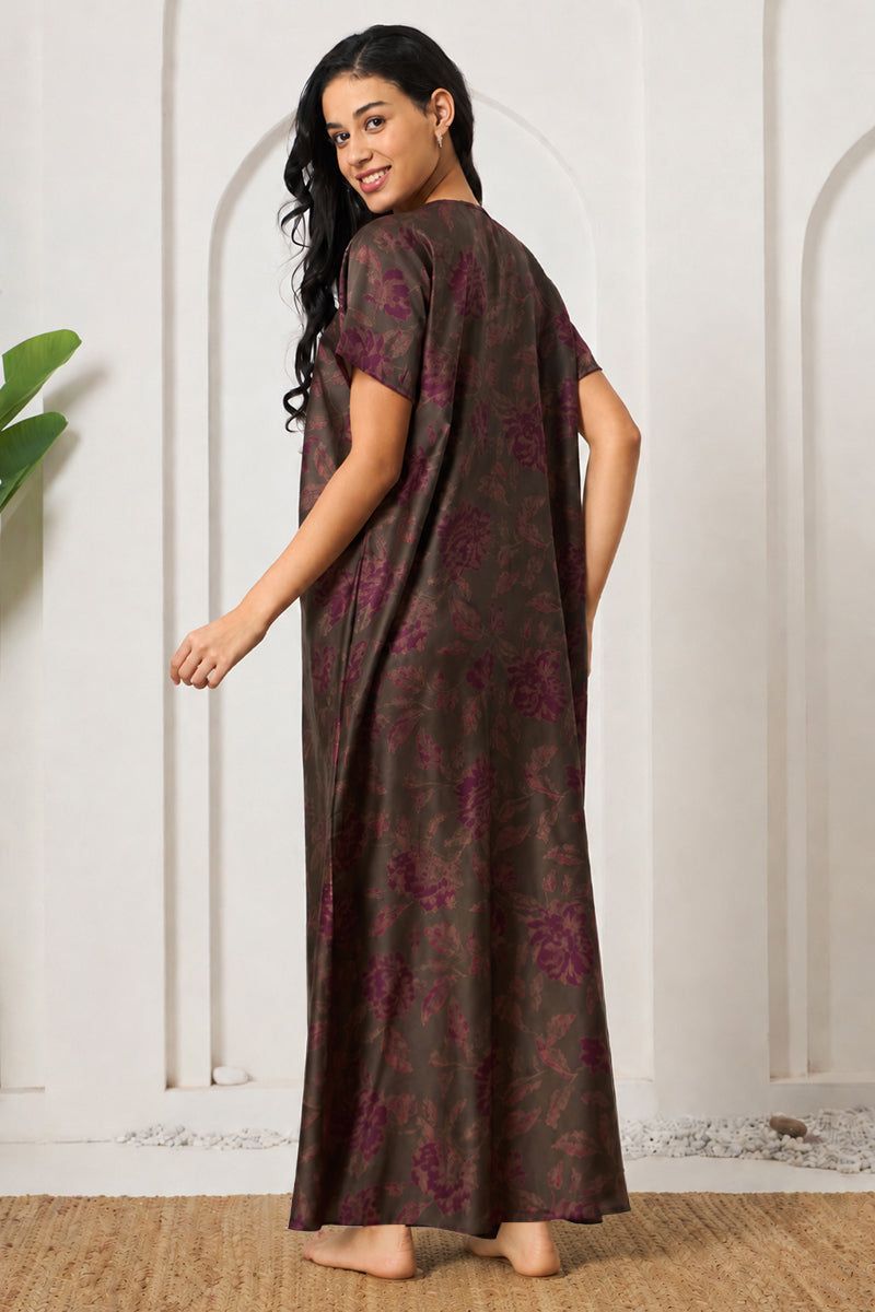 Back view of a woman in an olive and purple floral nightgown