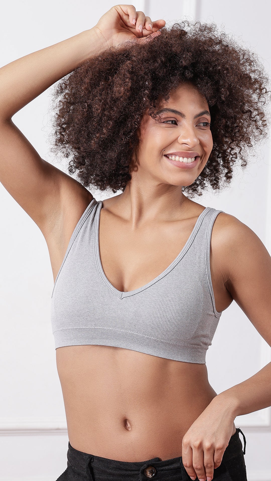 Model wearing beige ribbed V-neck wireless bra, front view