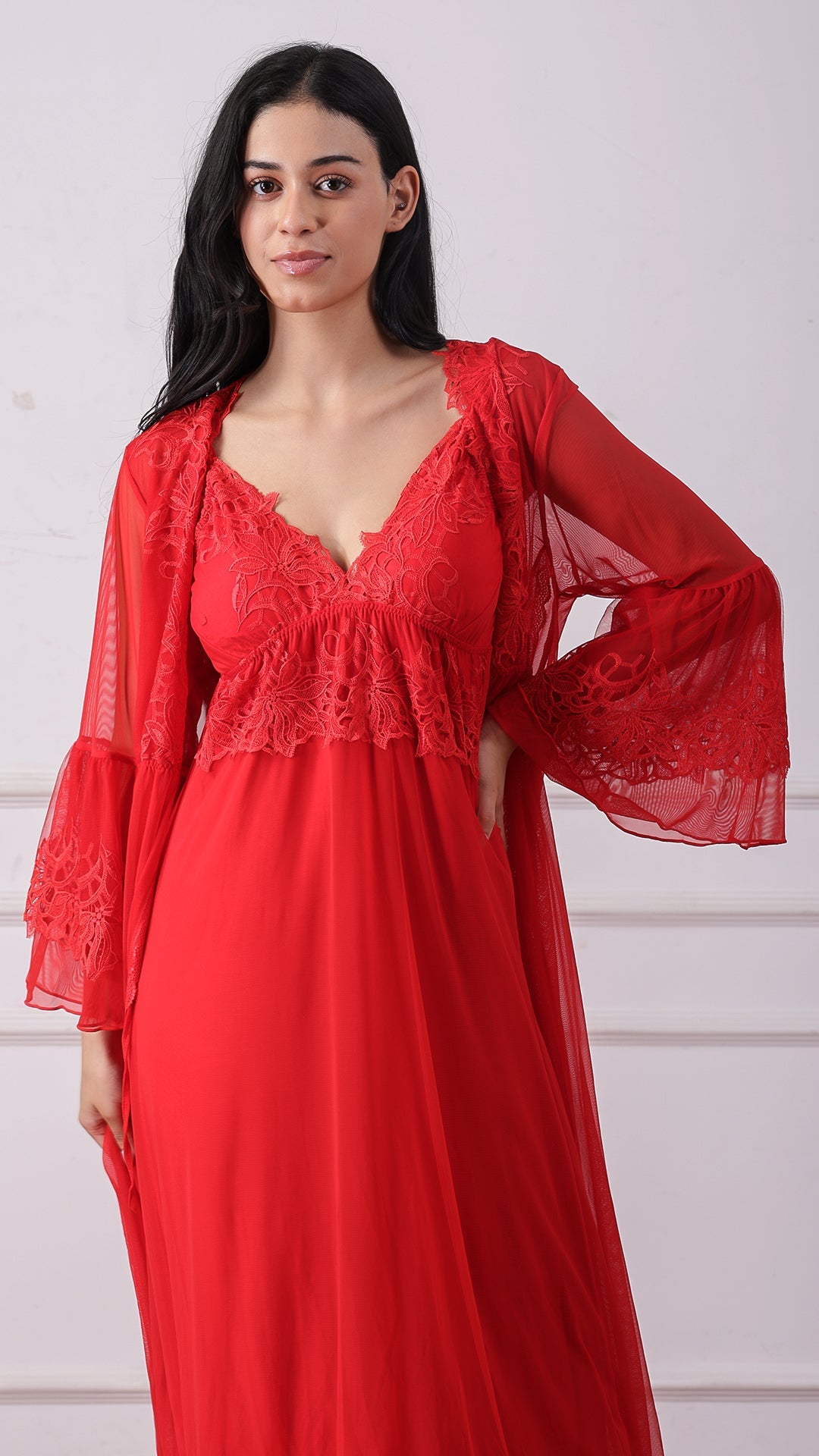 Close-up of woman wearing a red lace-trimmed nightdress and sheer robe
