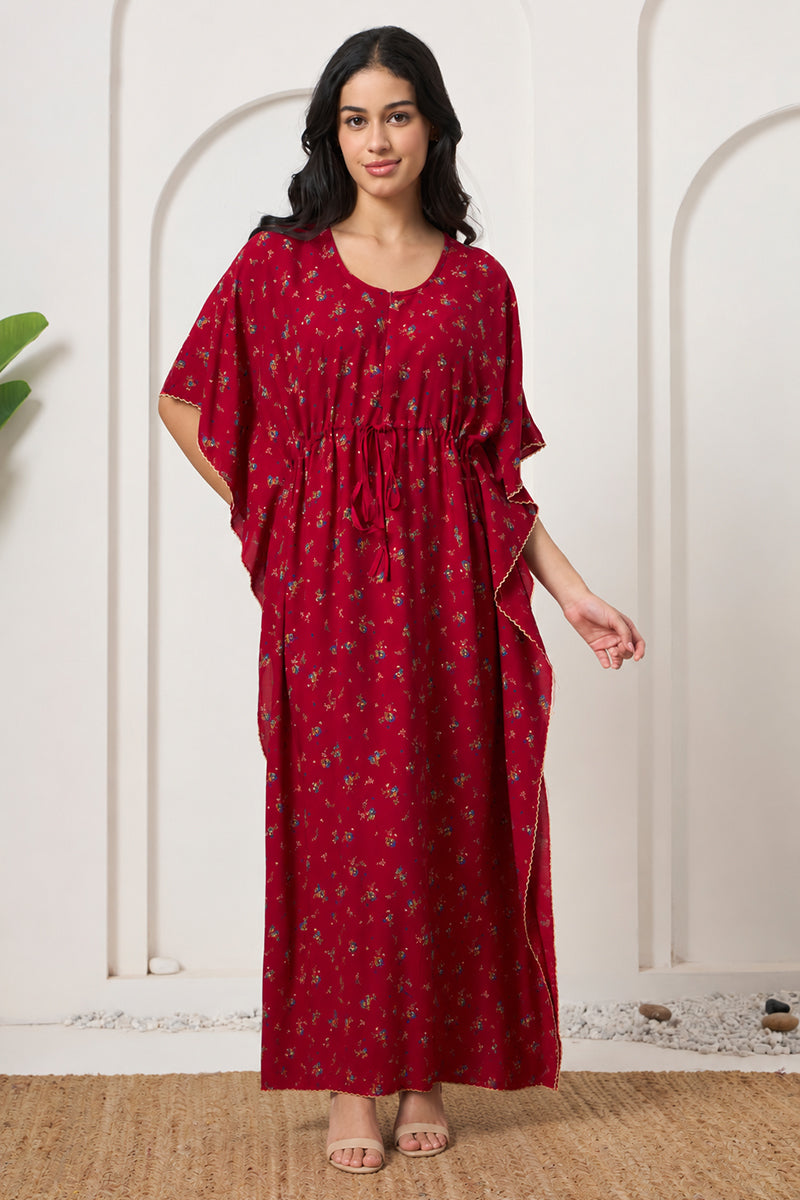Woman standing in a red ditsy floral kaftan