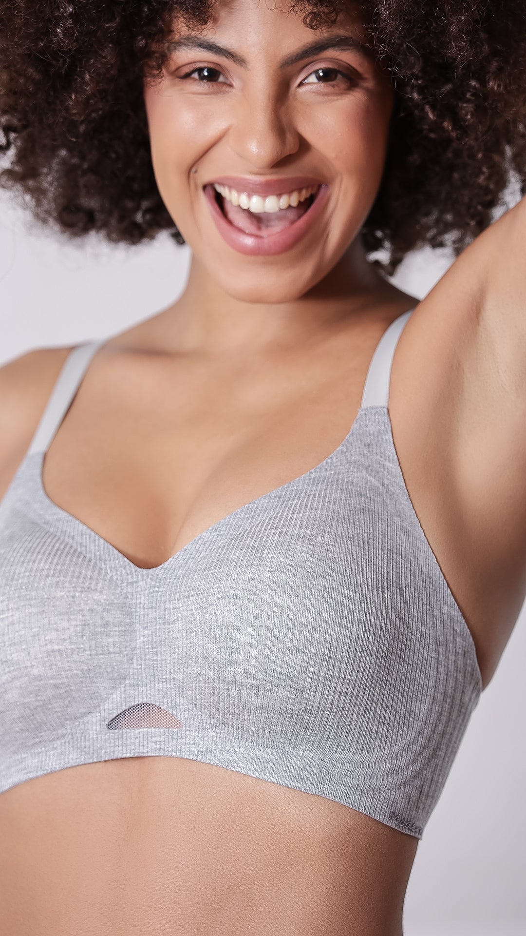 Close-up of grey ribbed second skin bra showing V-neckline and mesh cutout detail