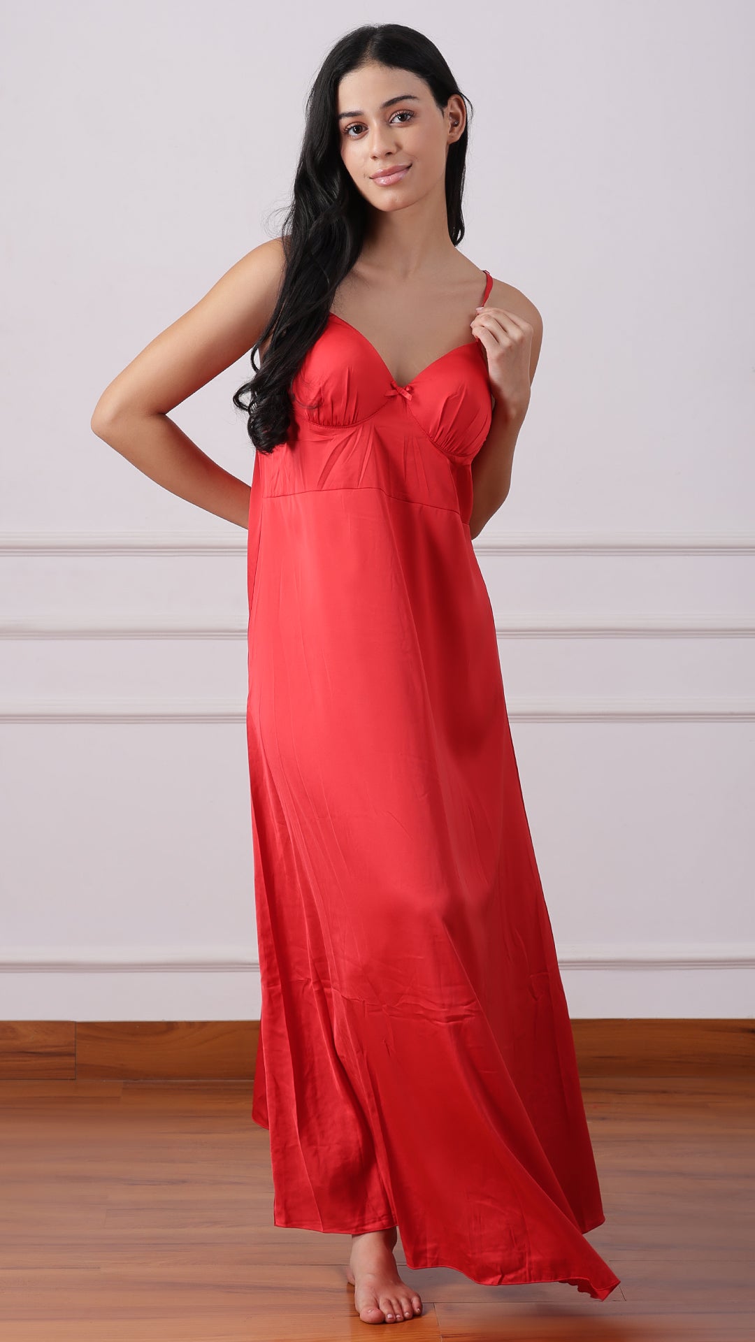 Back view of woman wearing red satin nightgown with thin straps