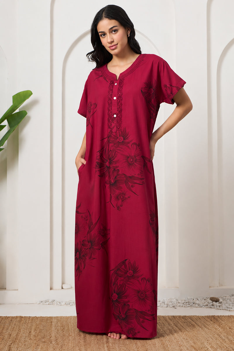 Woman smiling in a maroon floral print nightgown