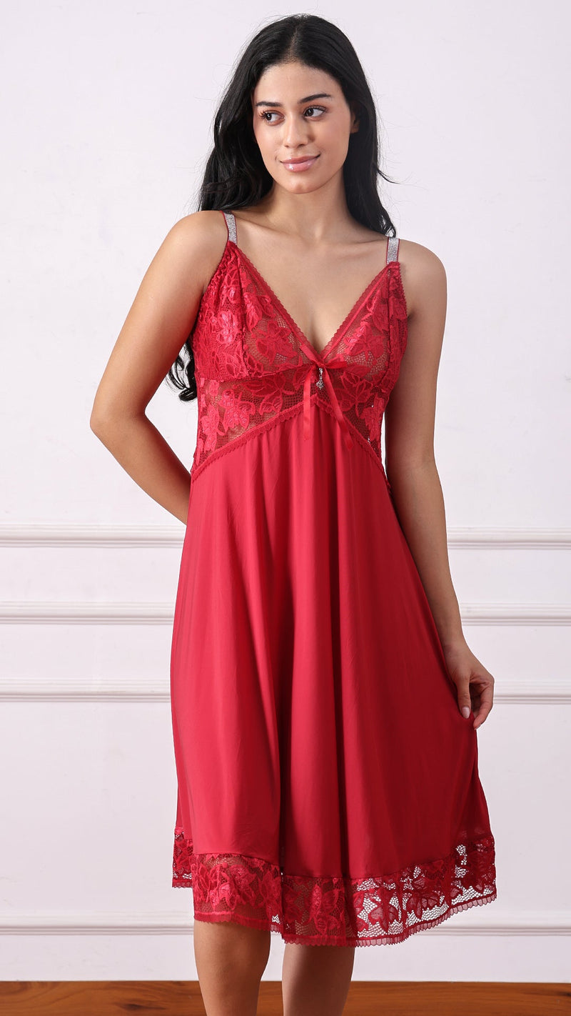 Woman wearing a red satin nightdress with lace bodice and shimmer straps
