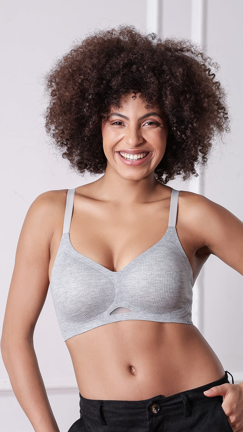 Woman wearing grey ribbed seamless T-shirt bra with thin straps and black pants