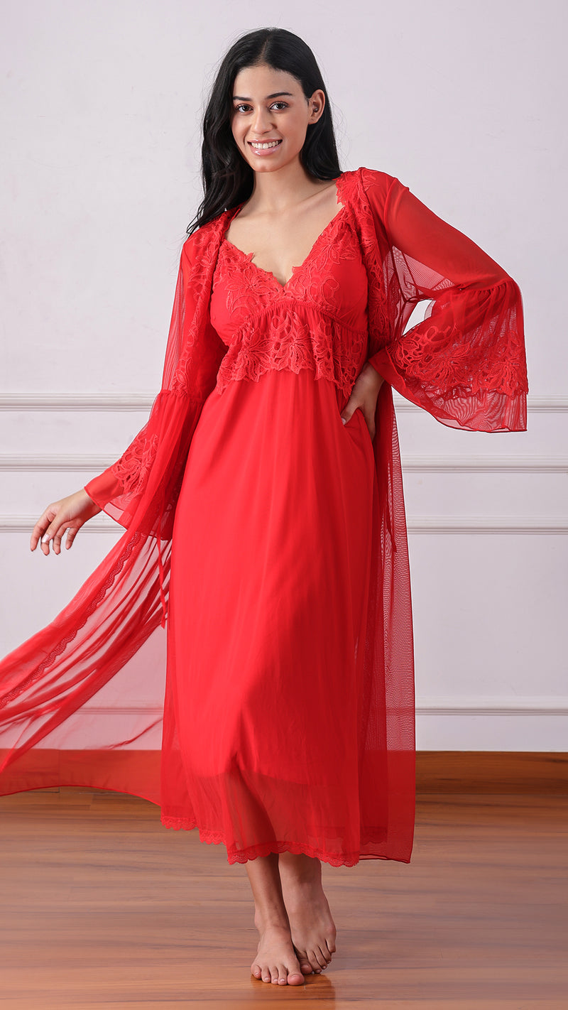 Woman wearing a red lace-trimmed nightdress and sheer robe, smiling