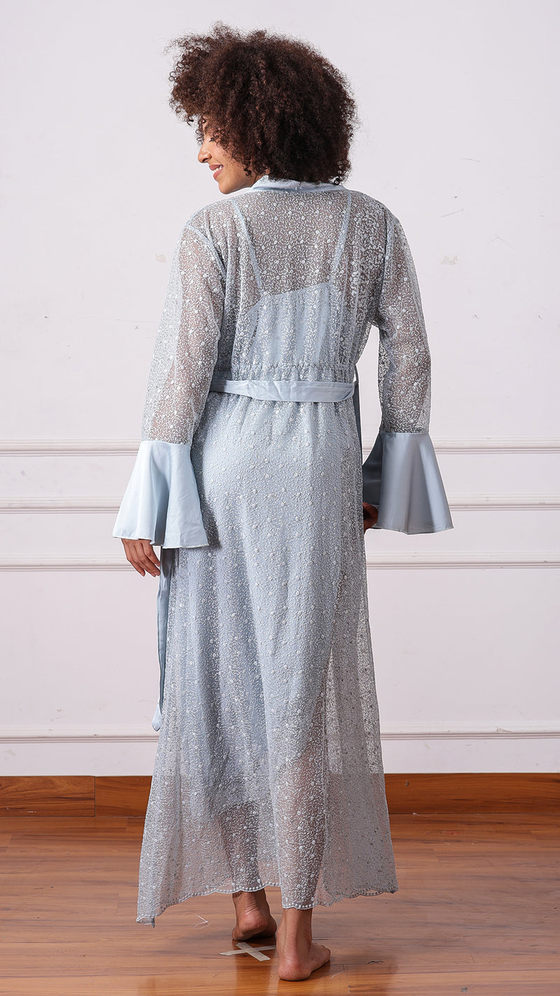 Back view of woman wearing pale blue sheer floral lace robe