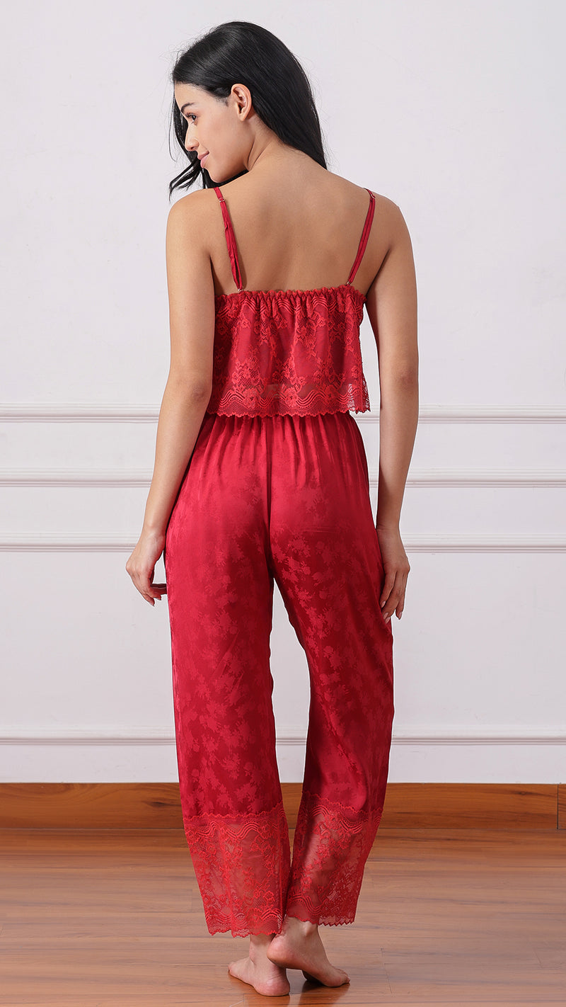 Back view of woman wearing a red lace cami and satin pyjama set