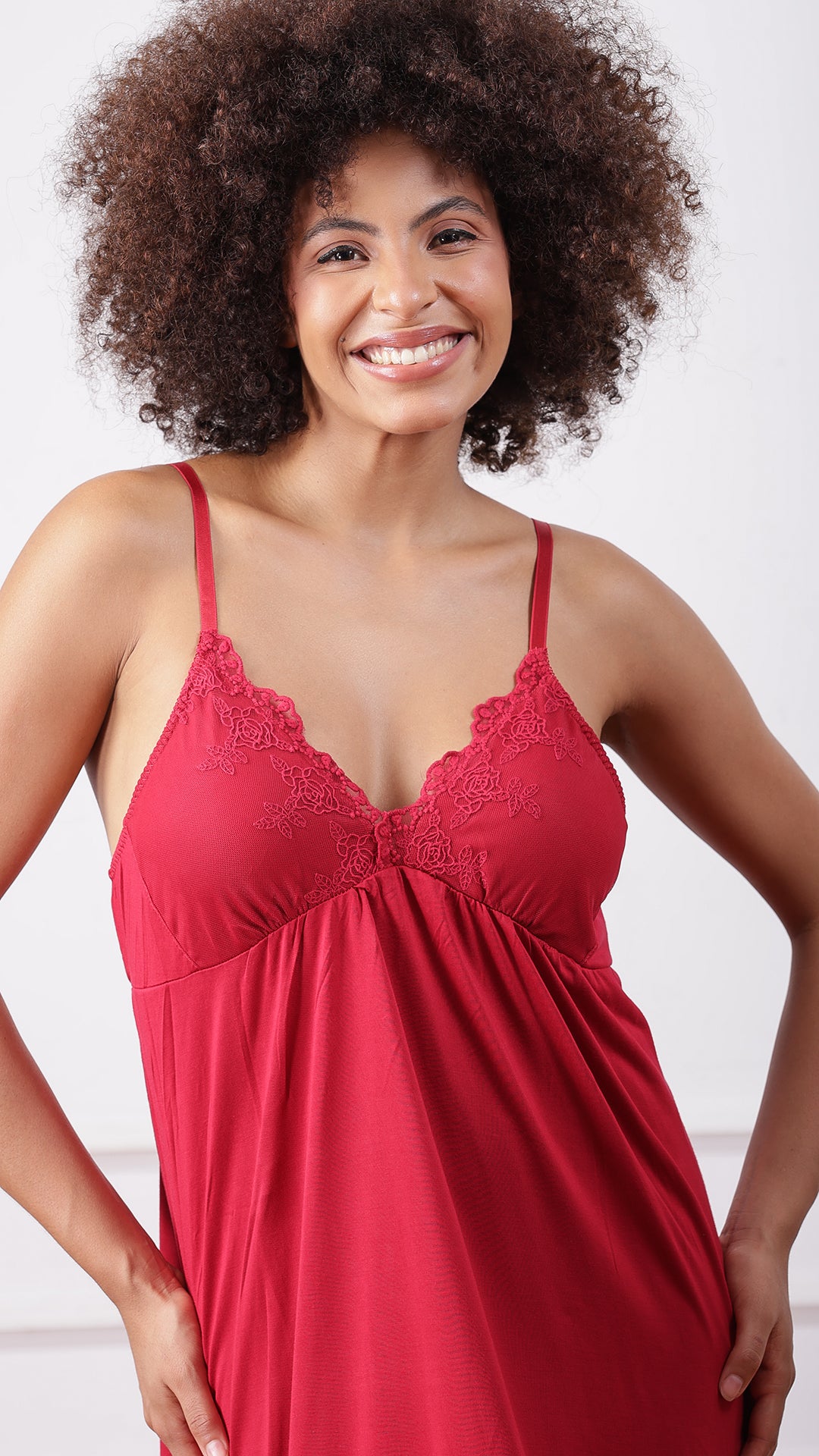 Close-up of red jersey nightdress with floral lace neckline