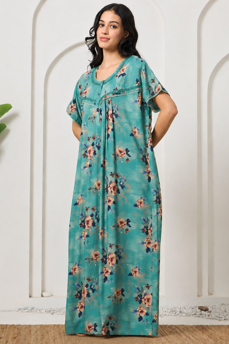 Woman posing sideways in a teal floral maxi nightgown