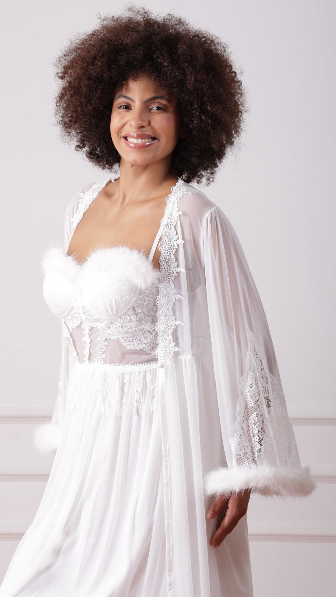 Close-up of woman wearing white lace bodice with feather trim
