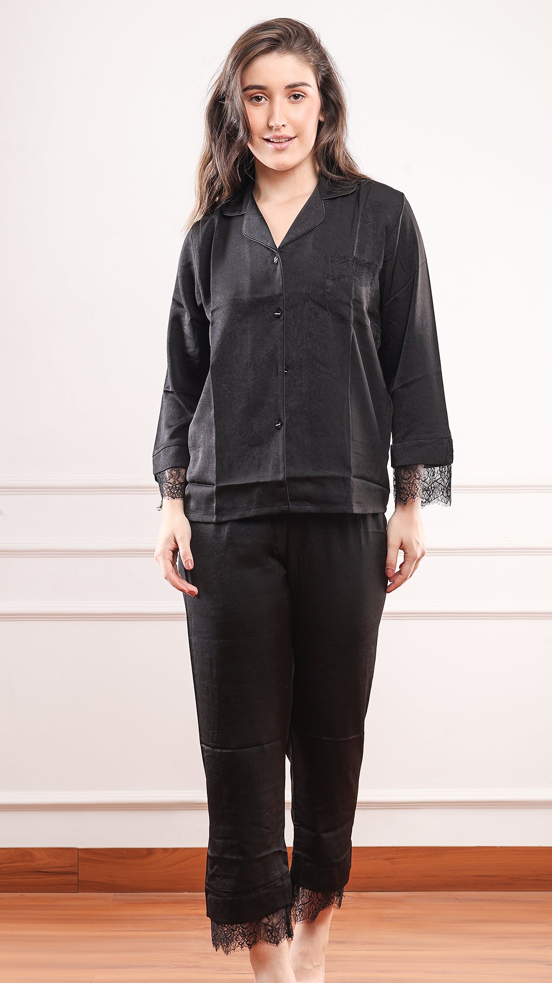 Full length front view of black satin lace trim pajama set with straight leg pants and lace hem detail