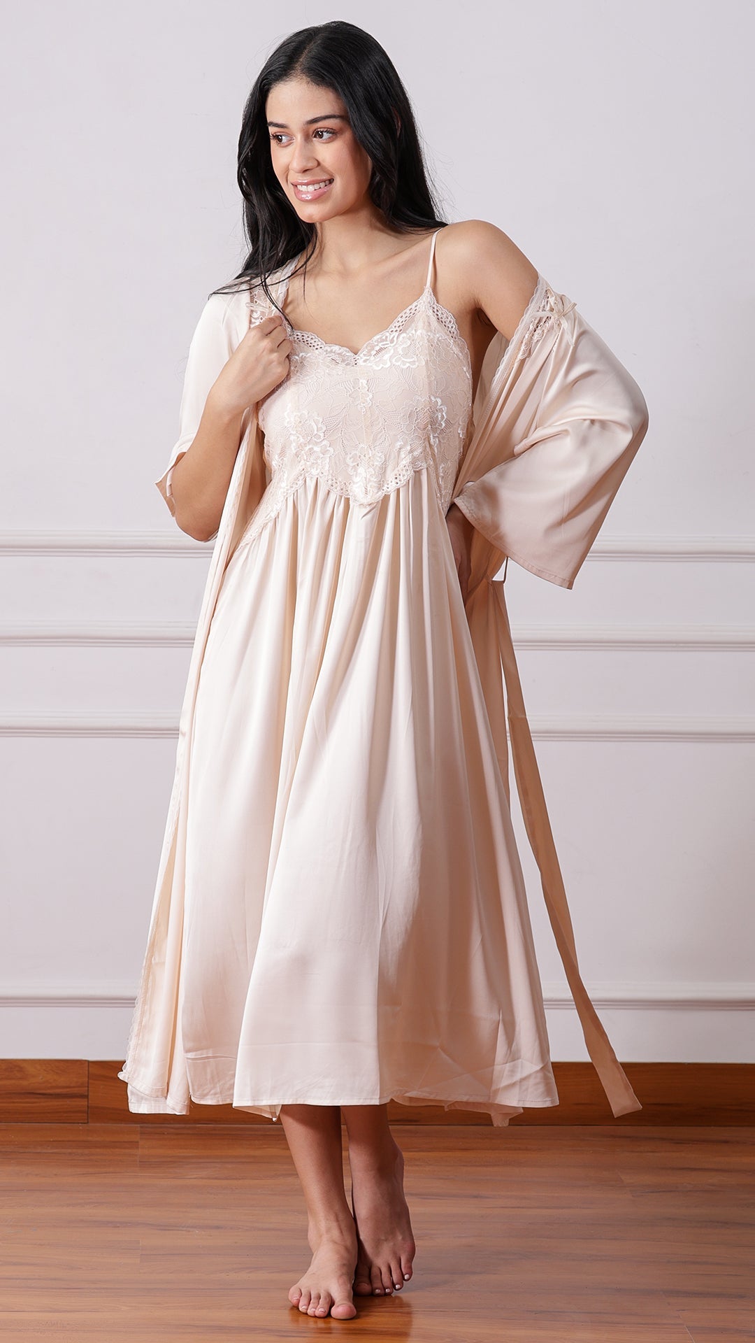 Woman wearing beige satin lace nightgown with matching tie-waist robe