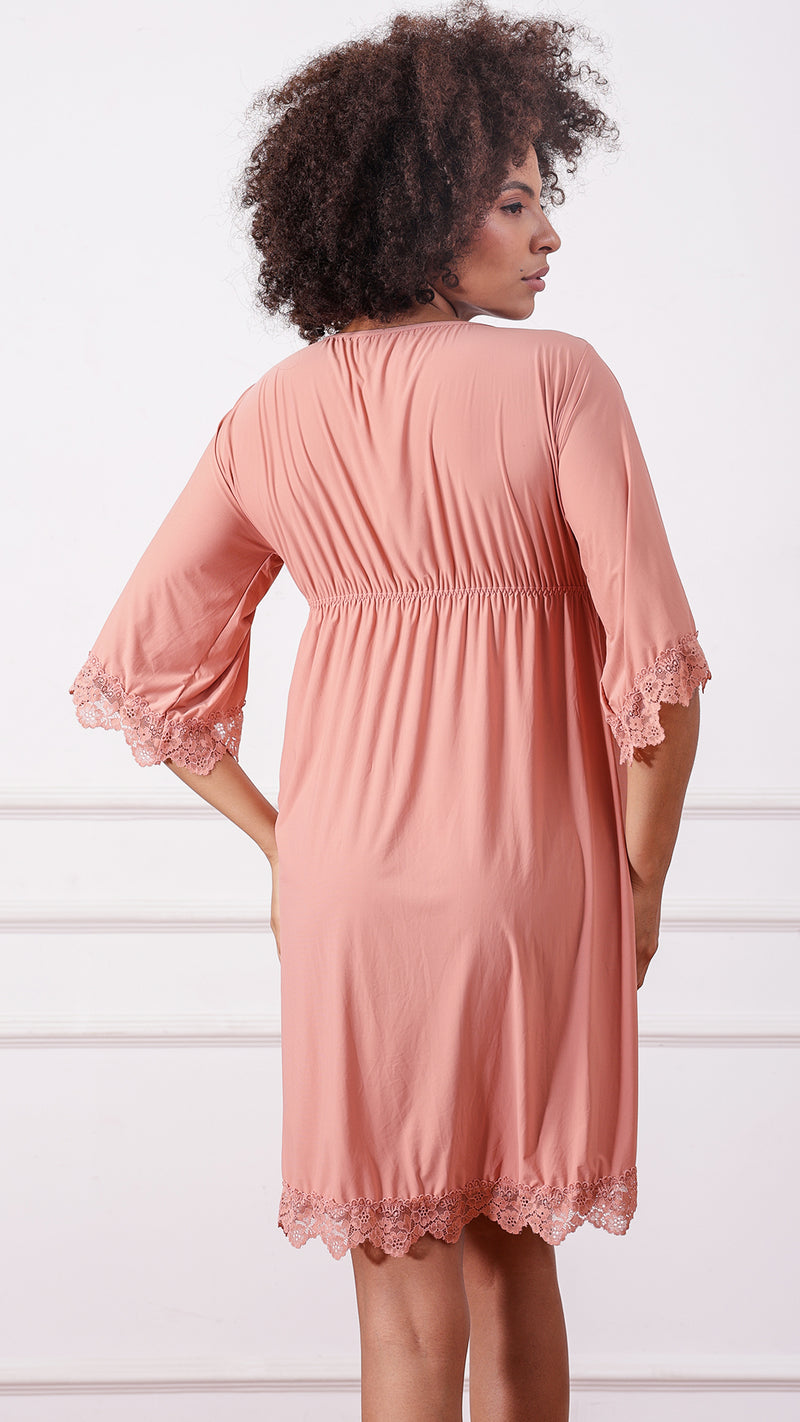 Back view of woman wearing a pink lace-trimmed nightdress