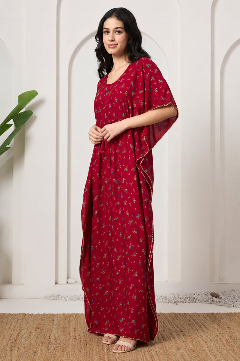 Woman posing sideways in a red floral print kaftan