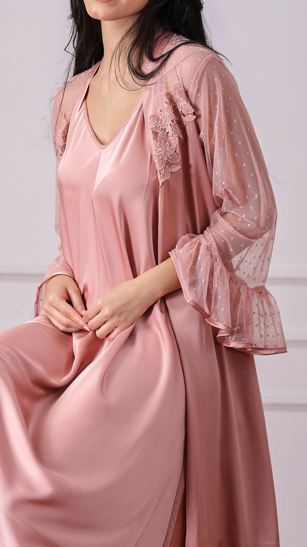 Close-up of dusty pink robe sleeve with floral lace applique