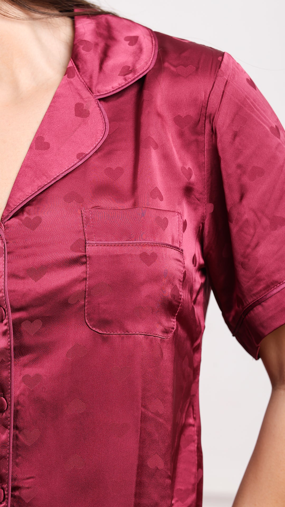 Close-up of wine satin pajama shirt with heart jacquard and chest pocket