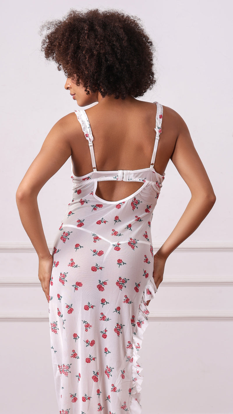 Back view of woman wearing white floral mesh dress with back cutout