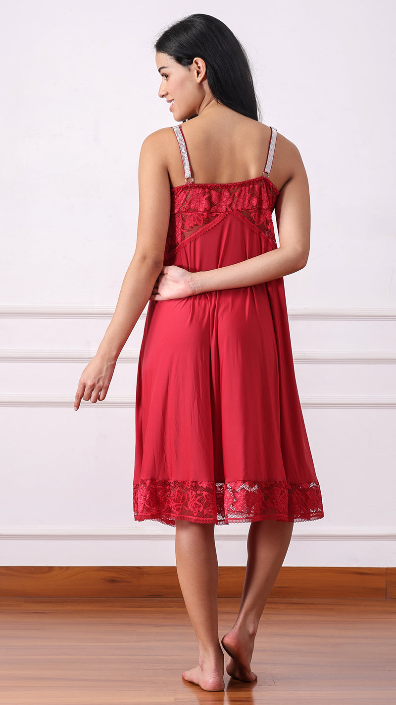 Back view of woman wearing a red satin nightdress with shimmer straps