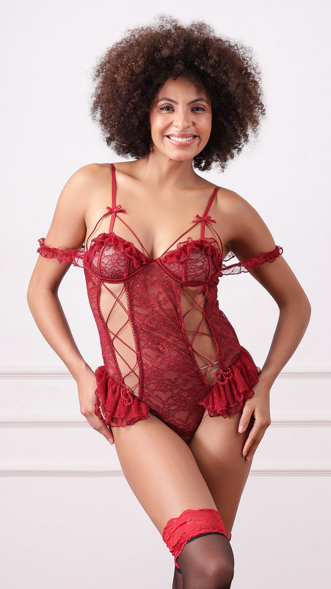 Woman posing in red lace teddy with off-shoulder ruffle sleeves