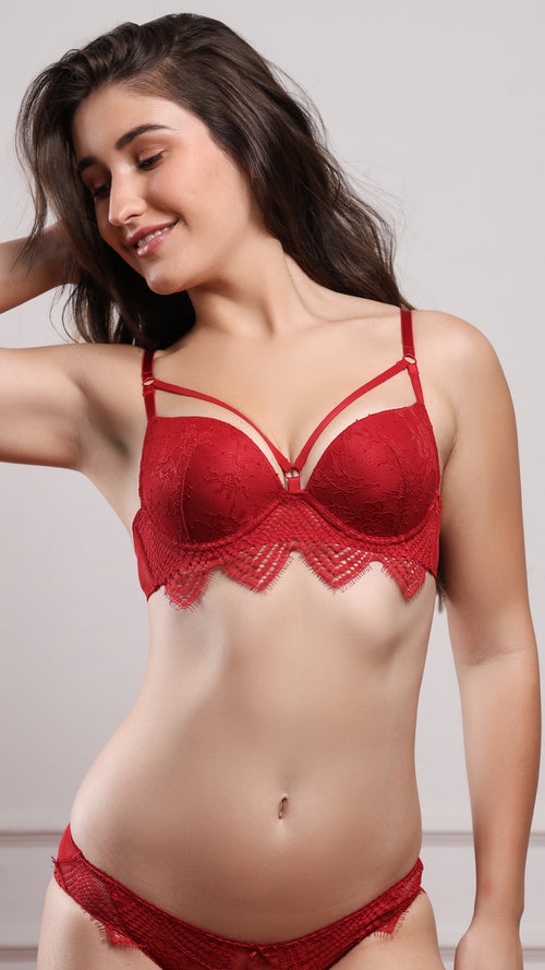 Woman wearing red lace push-up bra and matching brief, front view