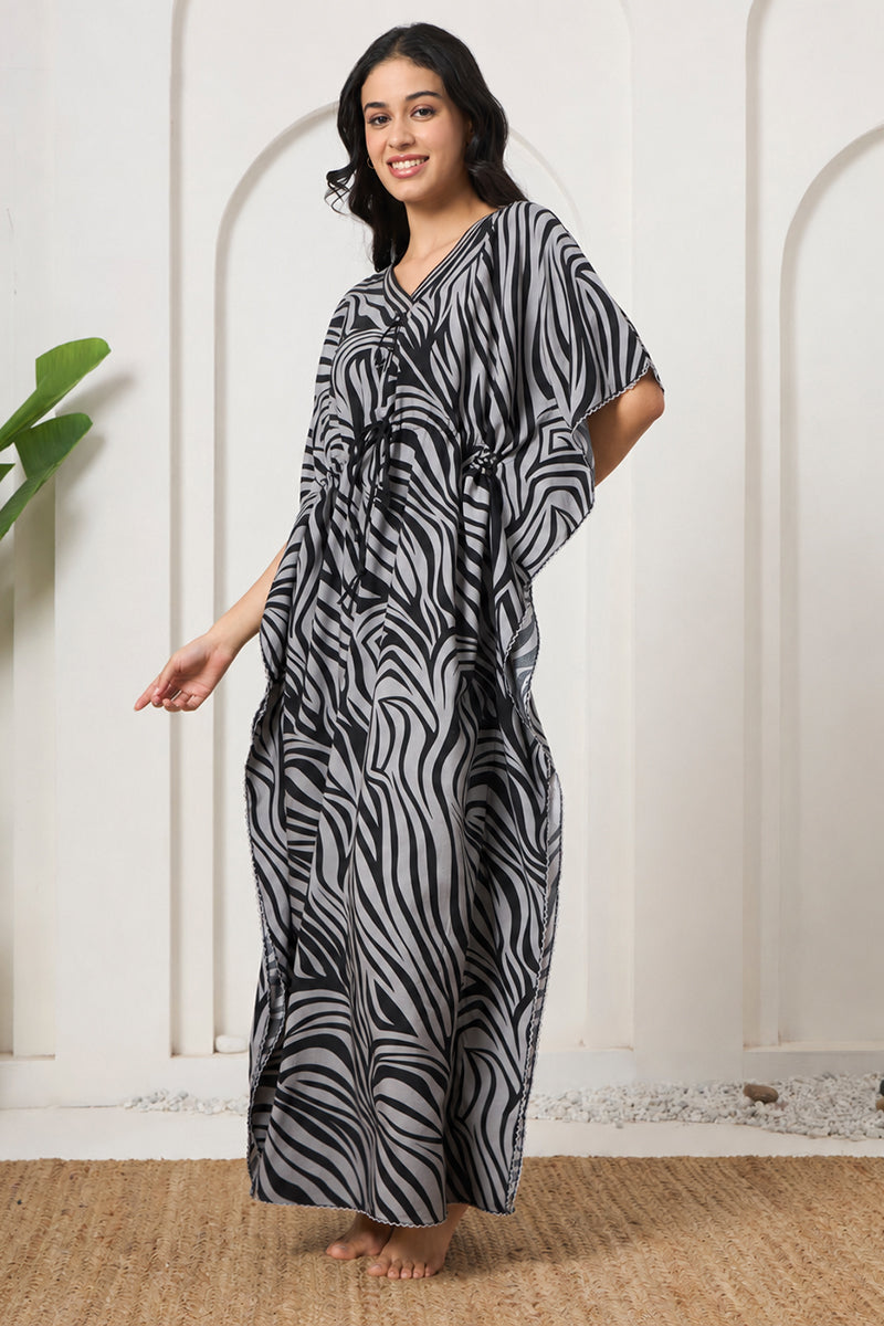 Woman posing in a zebra print kaftan with drawstring waist