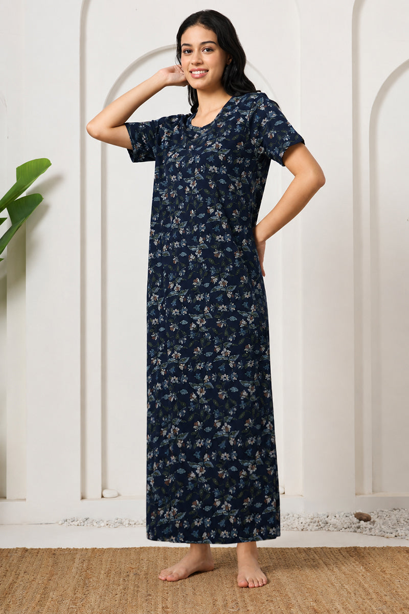 Woman posing in a navy floral print nightdress, hand on hip