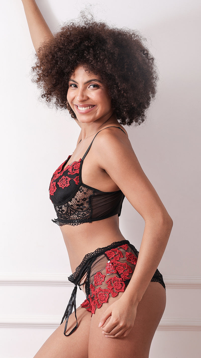 Black lace bra and panty set with red floral embroidery, side view
