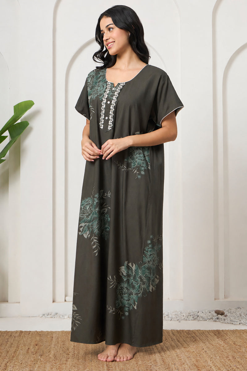 Woman standing in an olive green floral print maxi nightgown