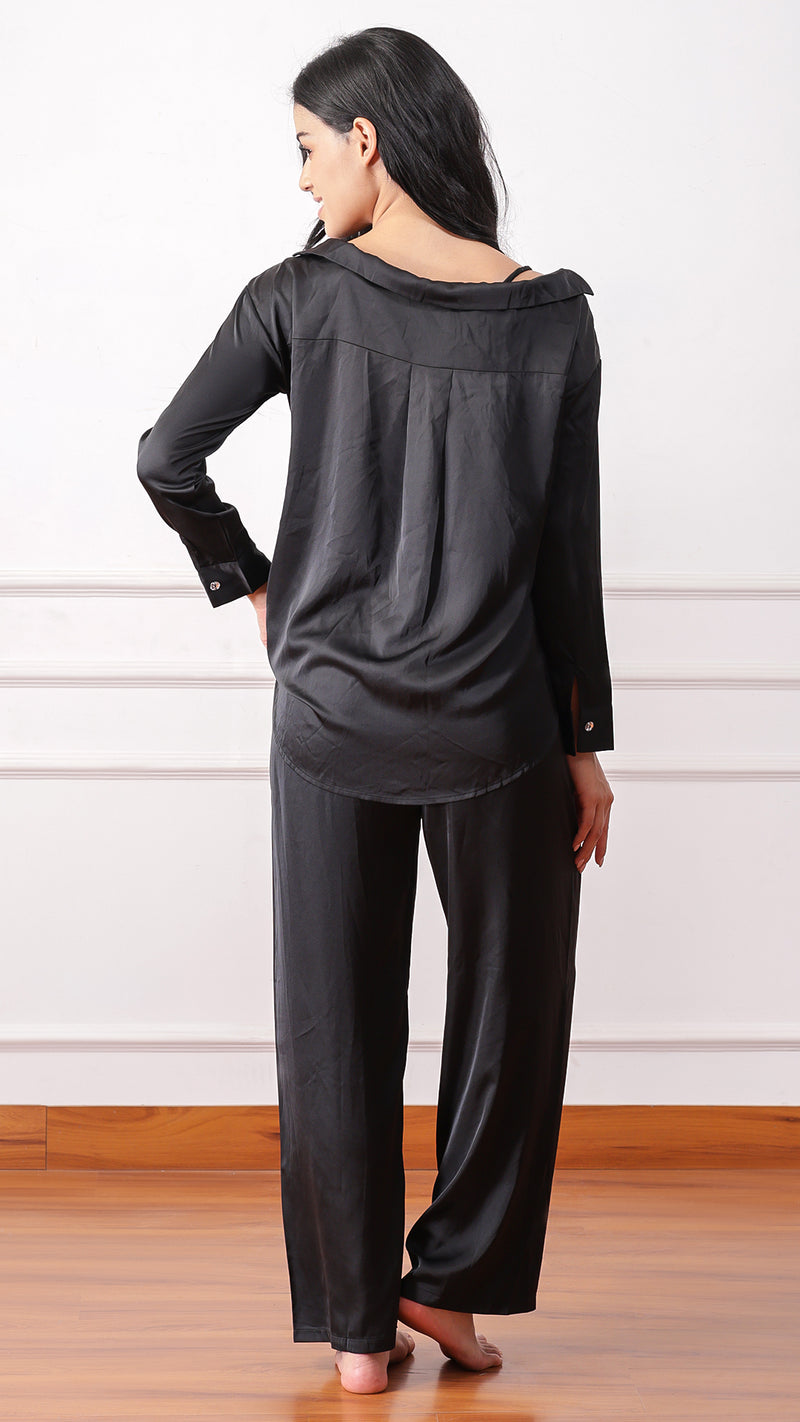 Back view of woman wearing black satin pyjama set