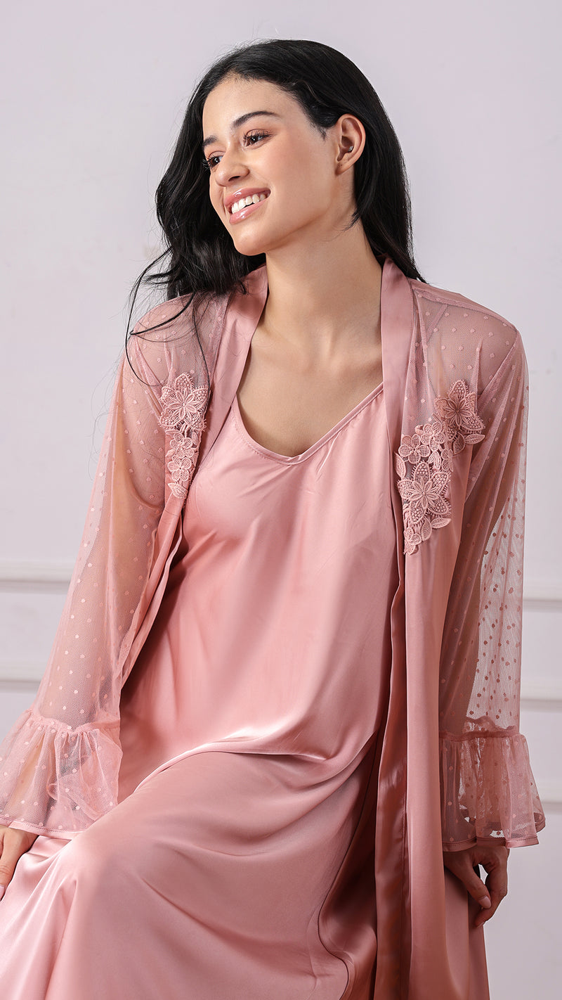 Close-up of woman wearing dusty pink satin dress with lace-appliqué robe