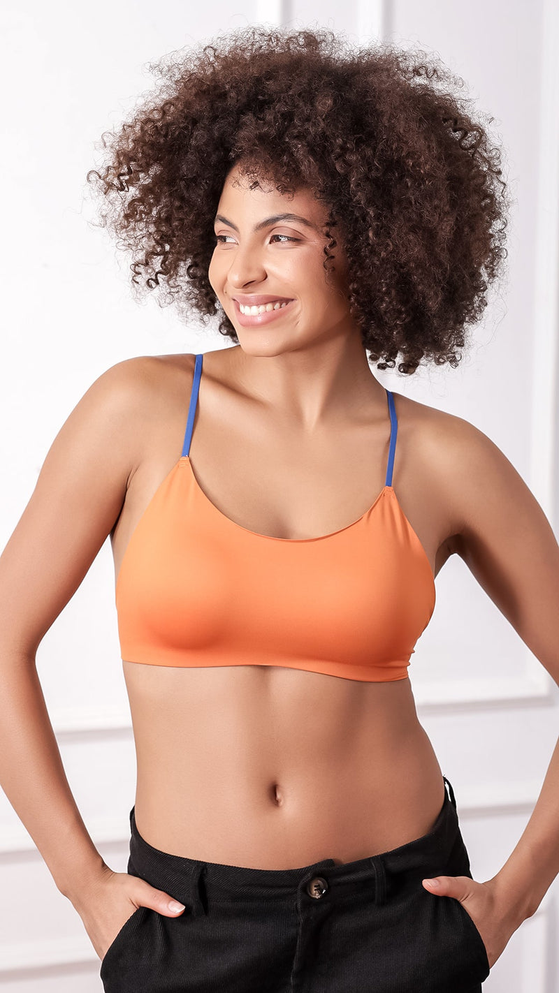 Woman wearing orange bralette with contrast blue straps