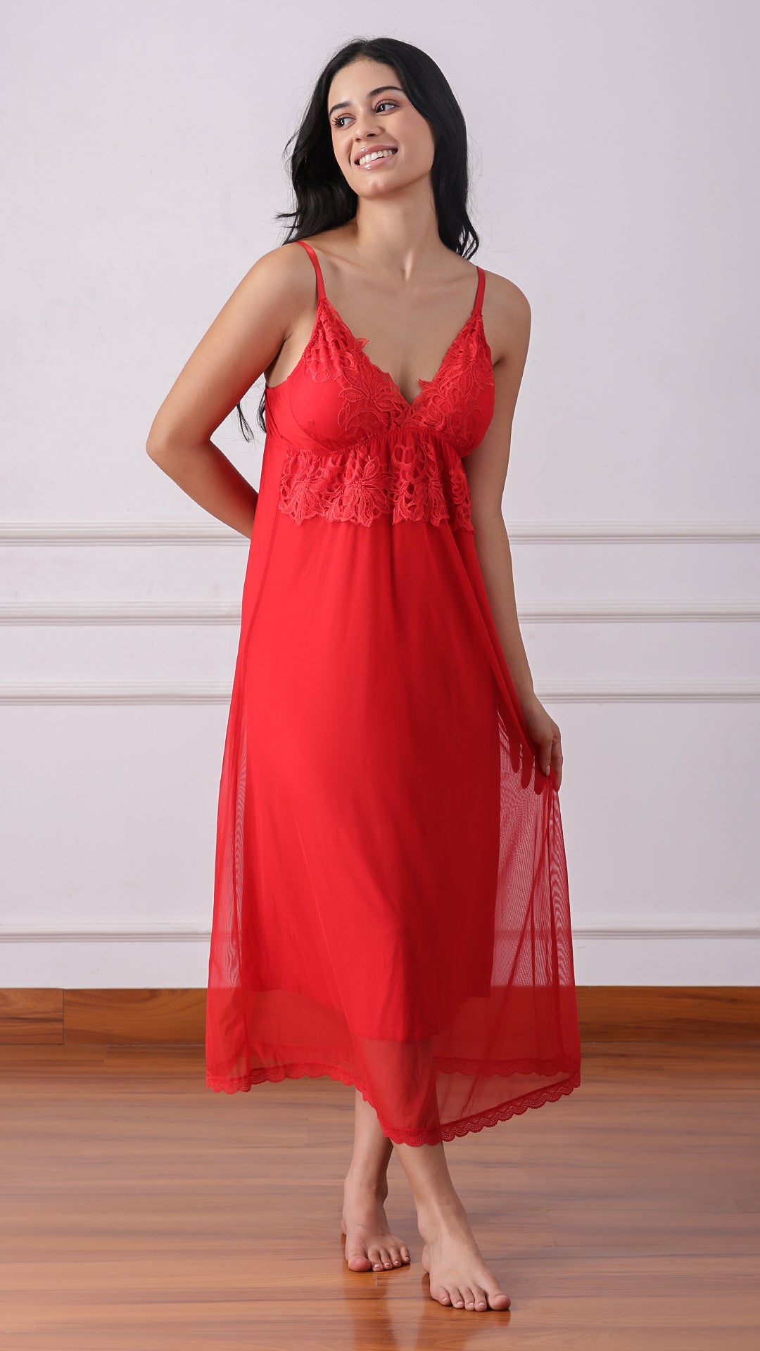 Woman wearing a red lace-trimmed nightdress and sheer robe, full length