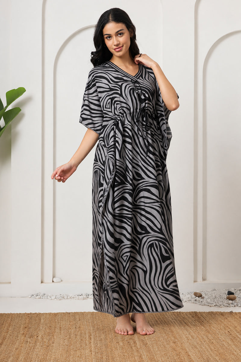 Woman standing sideways in a zebra print kaftan