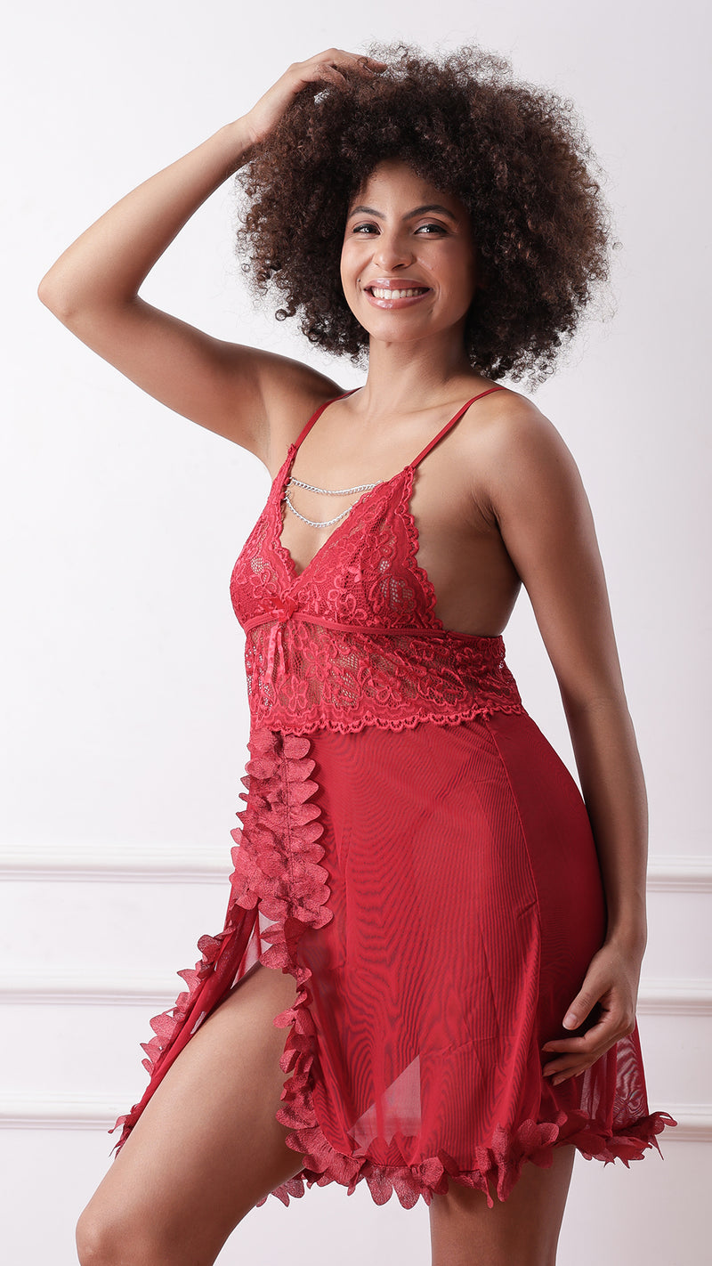 Side view of woman wearing red lace babydoll showing thigh-high slit