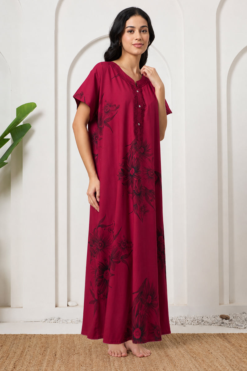 Woman posing in a maroon nightgown with lace button placket