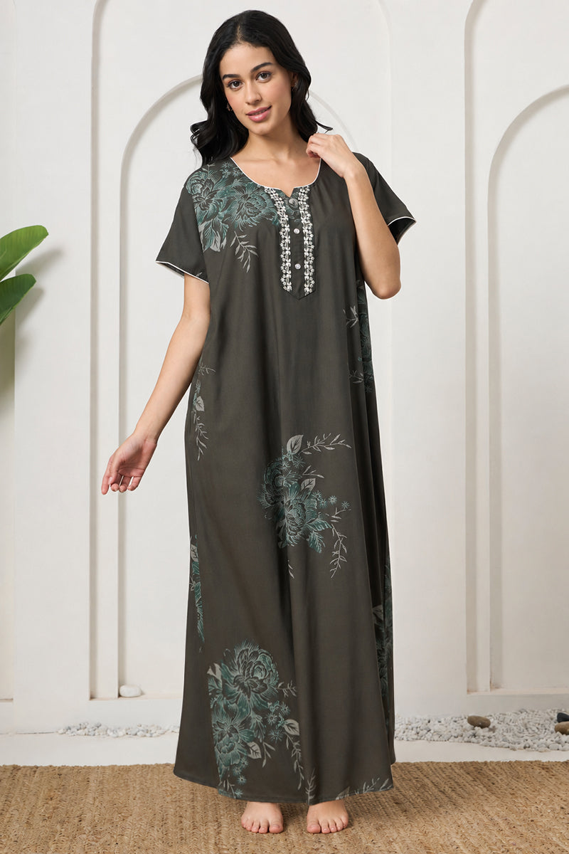 Woman posing in a floral print nightgown, looking to the side