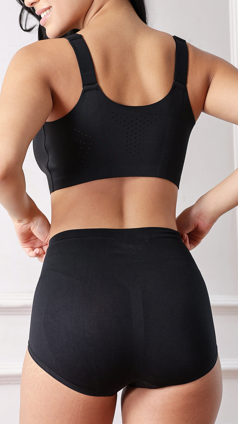 Back view of model wearing black sports bra and high-waist shaper brief