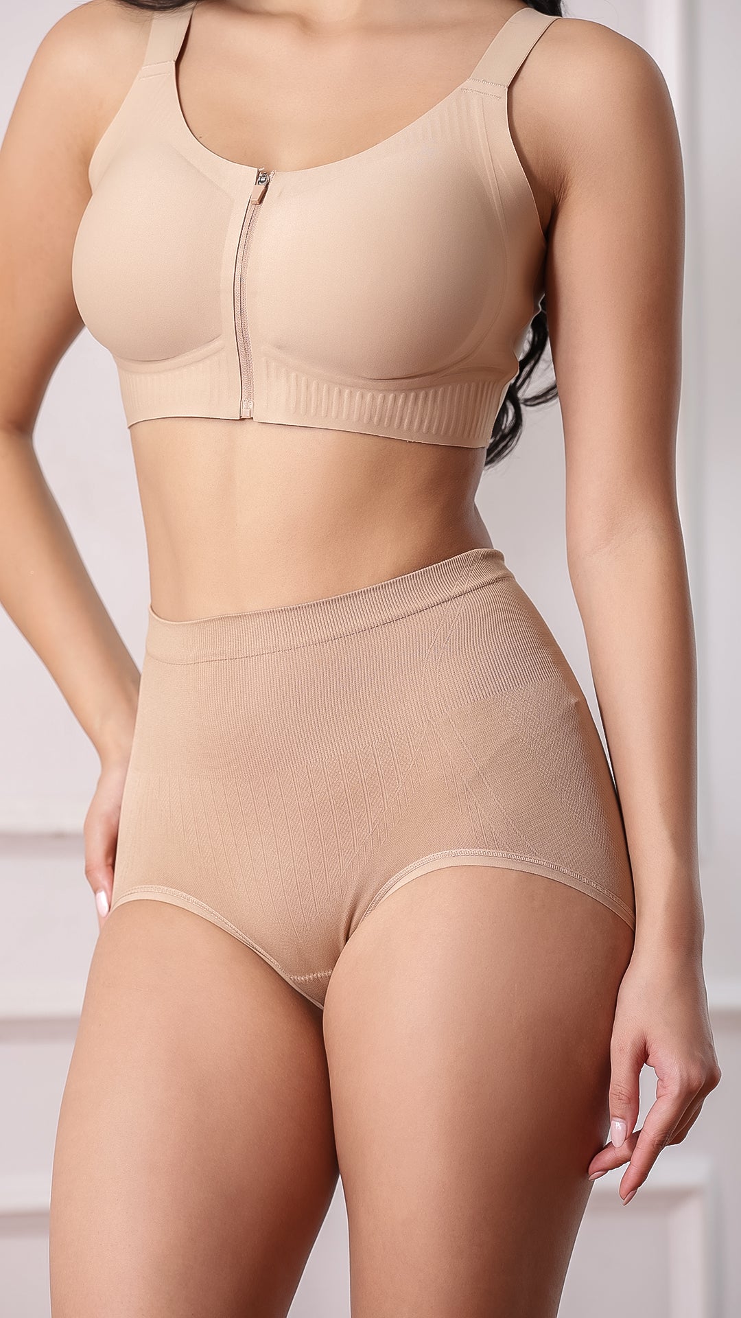 Close-up of beige high-waist shaper brief with ribbed front panel
